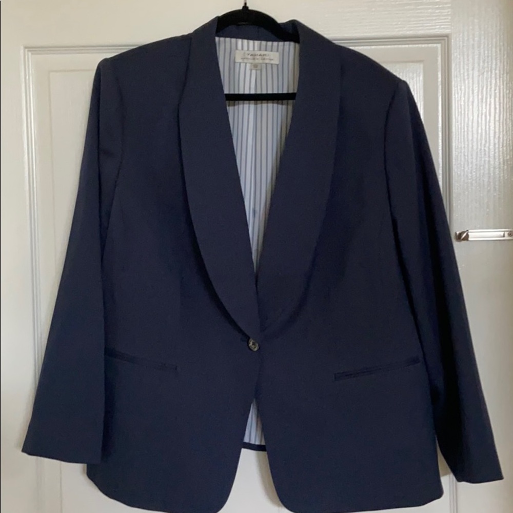 Navy blazer with front pockets and single button.